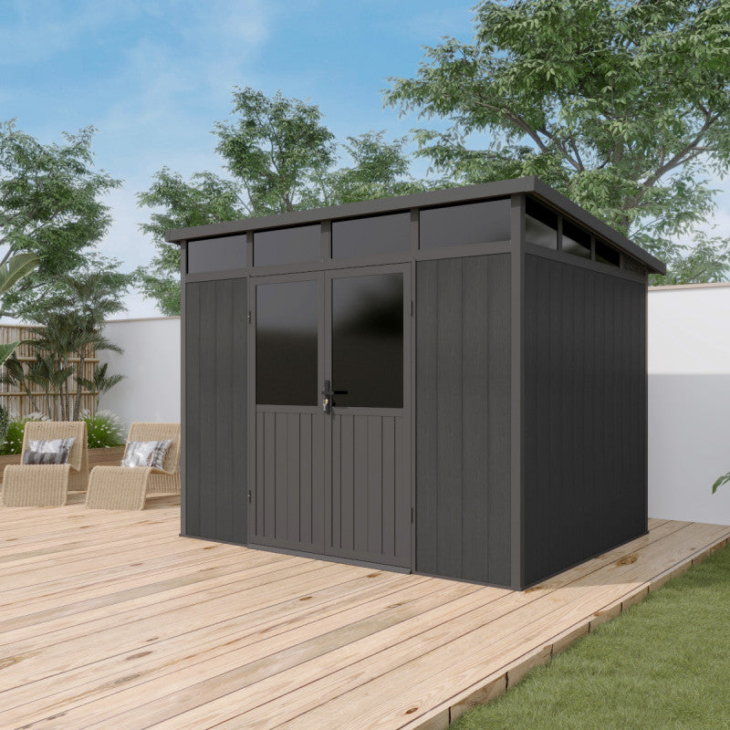 Black garden shed on a wooden deck with trees and a clear sky in the background